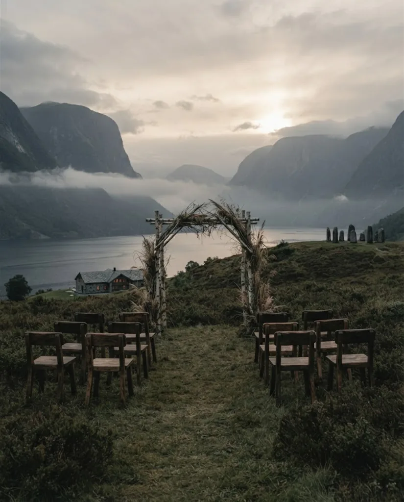 Artist's impression of a ceremony setting on a heather headland: wooden chairs and an arch of grasses before the fjord, with no people